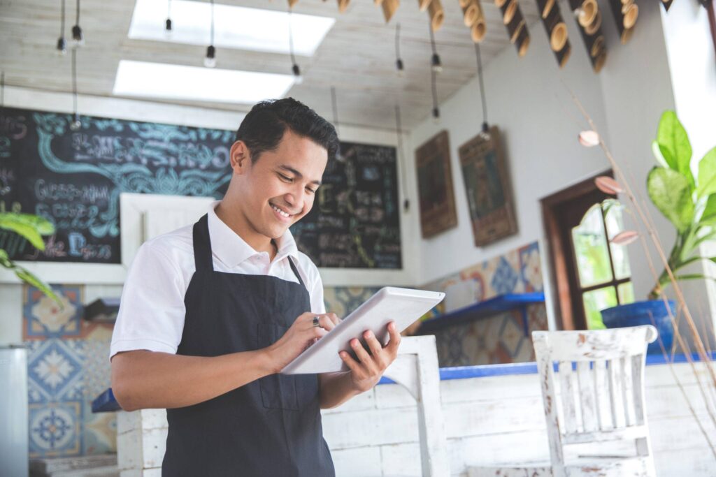 portrait of asian young male cafe owner with tablet